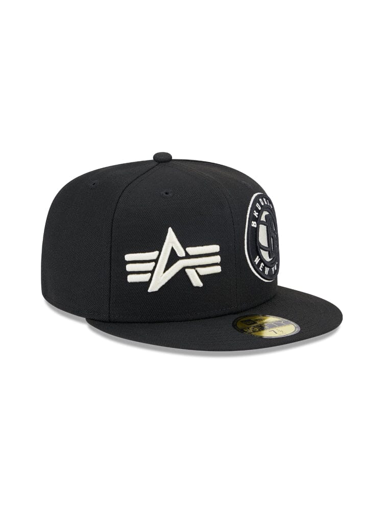 The Brooklyn Nets x Alpha x New Era 59Fifty Fitted Cap boasts a sleek black design with a white team logo on the front and a circular patch on the side, making it ideal for fans who appreciate classic style and the quality of Alpha Industries.