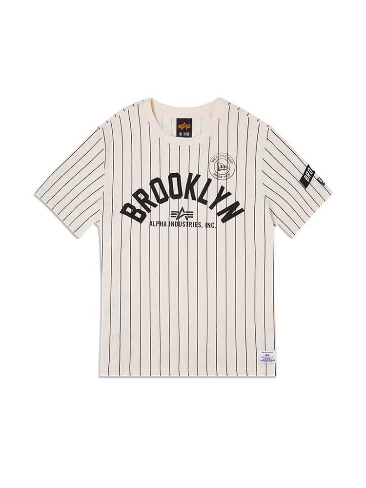 Brooklyn Nets X Alpha X New Era Tee by Alpha Industries / NE-NBA is a white shirt adorned with black vertical pinstripes, "Brooklyn" text, and NBA team logos on the chest and sleeves.