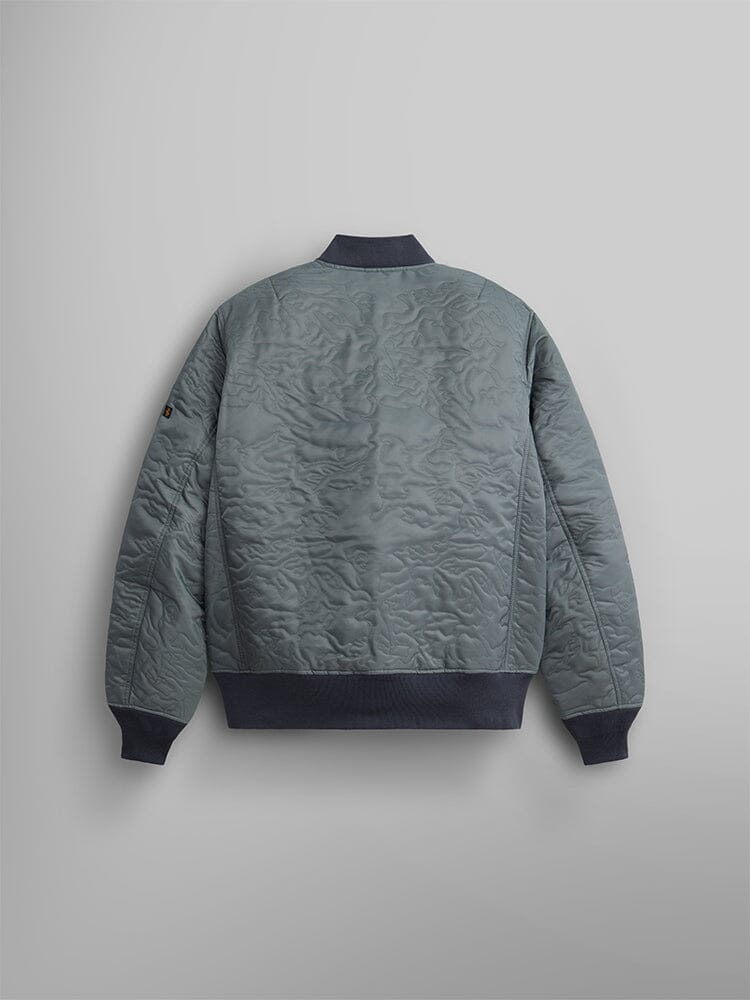 Back view of the Camo Quilted MA-1 Bomber Jacket by Alpha Industries, featuring a dark collar and hem with an MA-1 utility pocket.