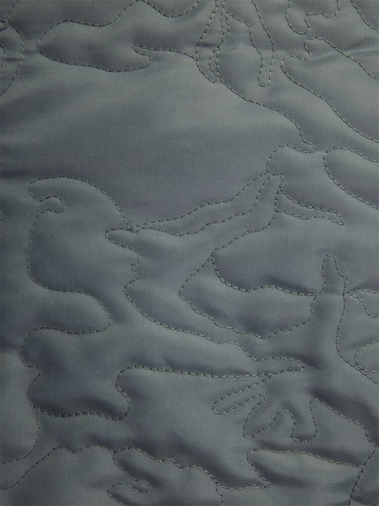 Detailed view of the abstract stitching pattern on the field gray fabric, reminiscent of quilted camo, from the Camo Quilted MA-1 Bomber Jacket by Alpha Industries.