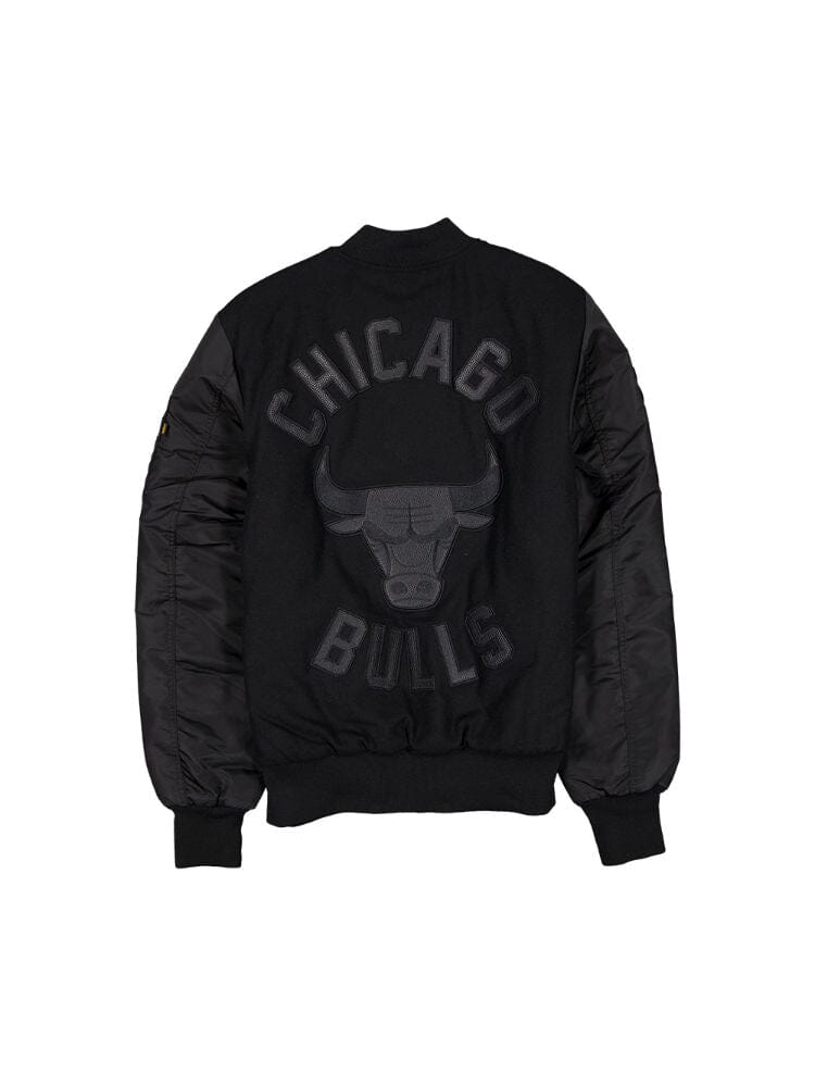 The Chicago Bulls x Alpha x New Era Wool Varsity MA-1 Bomber Jacket by Alpha Industries is a black bomber jacket adorned with a Chicago Bulls logo and lettering on the back, ideal for dedicated NBA fans.