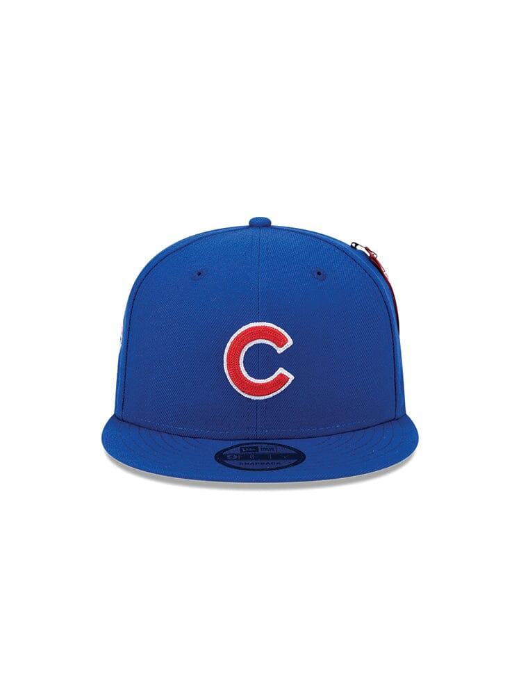 This Chicago Cubs X Alpha X New Era 950 Cap from Alpha Industries features a striking red and white "C" logo on the front. With its fashionable snapback closure, it seamlessly blends style with functionality, offering an adjustable fit to proudly display your team spirit.