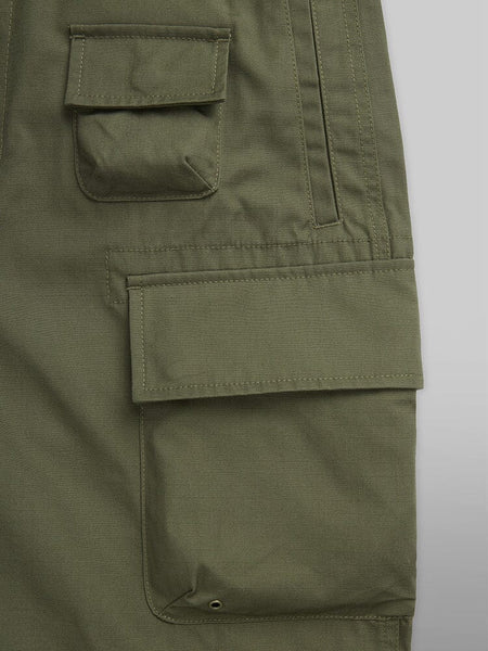 Alpha Industries Convertible Cargo Pant in OG-107 Green, with Two Flap Pockets, Button Closures, and Stitched Details.