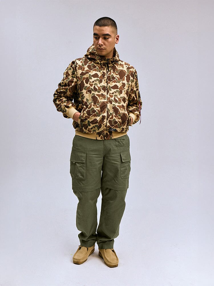 Alpha Industries Convertible Cargo Pant, OG-107 Green, Featuring Multiple Pockets and Zip Closures.
