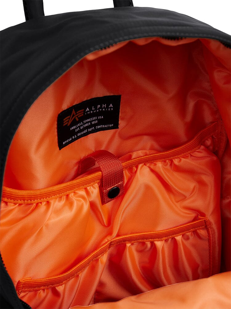 Alpha Industries Crew Backpack Gen II, black flight nylon, orange lining, mesh pockets, interior laptop sleeve, fabric brand label.