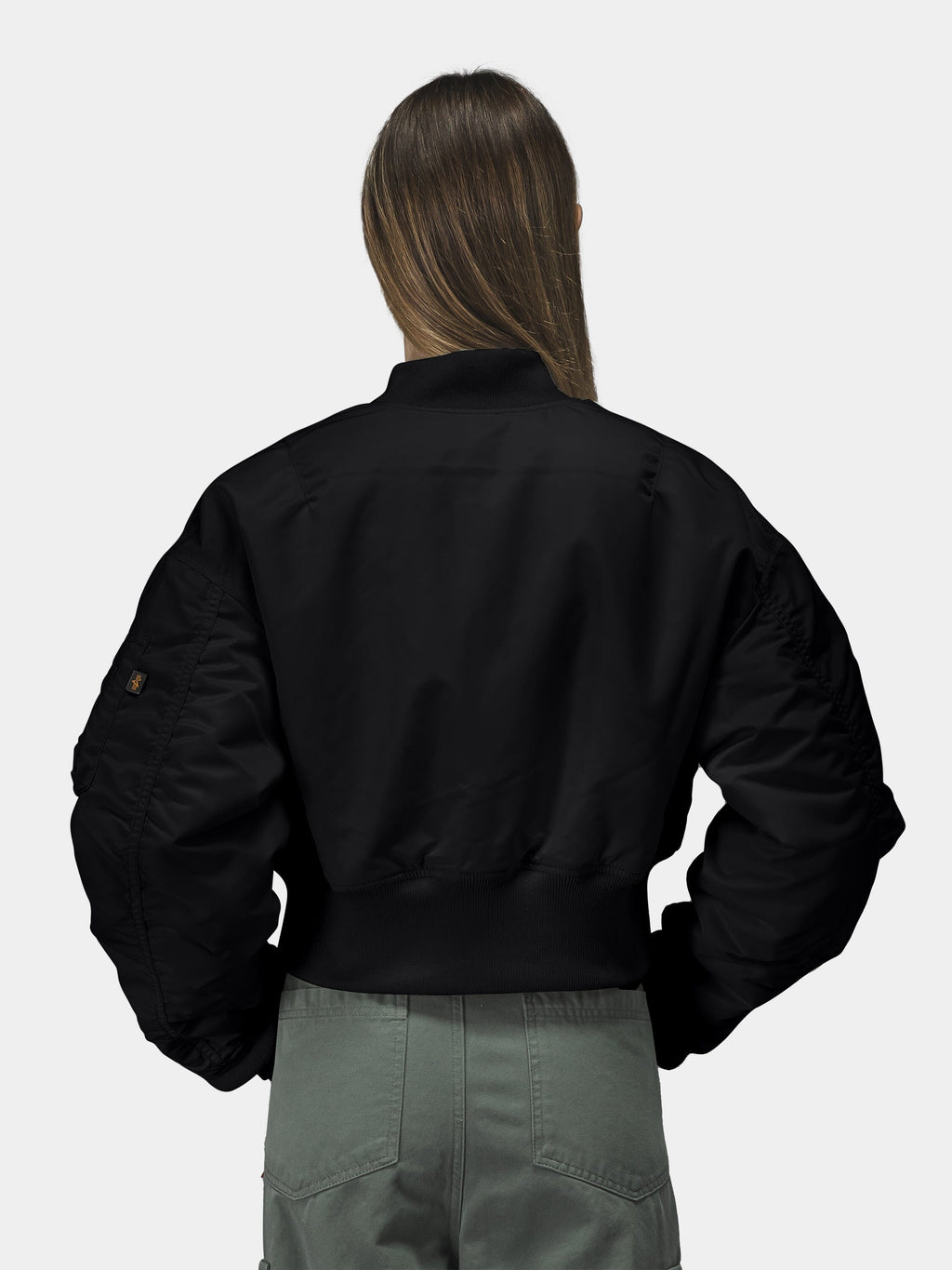 Alpha Industries Cropped MA-1 Flight Jacket Womens in black, paired with olive green pants.