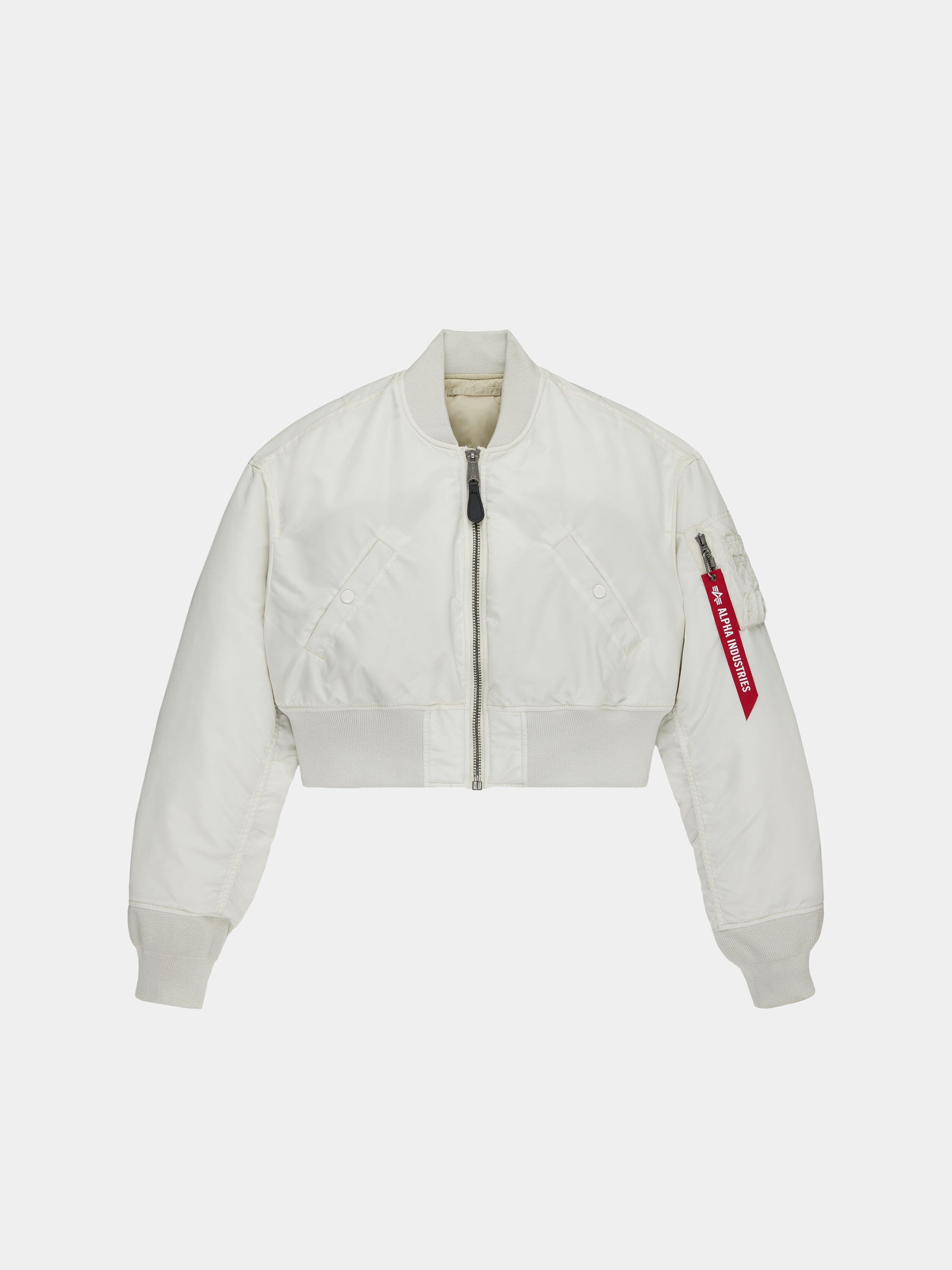Alpha Industries Cropped MA-1 Flight Jacket Womens in Dune White with front zip, ribbed cuffs and hem, sleeve pocket with red tag.