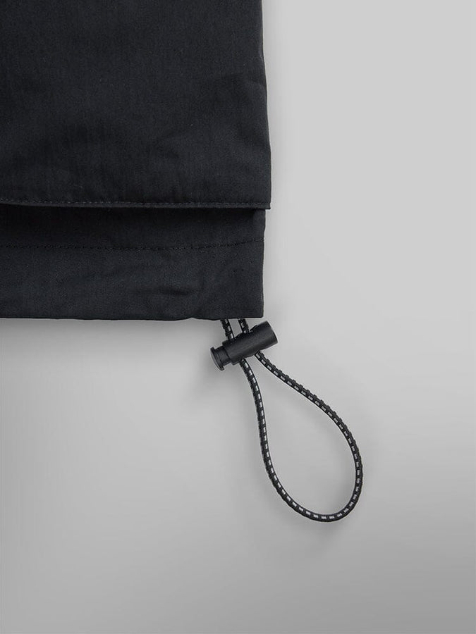 Alpha Industries CWU 36/P Pull On Short, black fabric with elastic drawstring and plastic toggle.