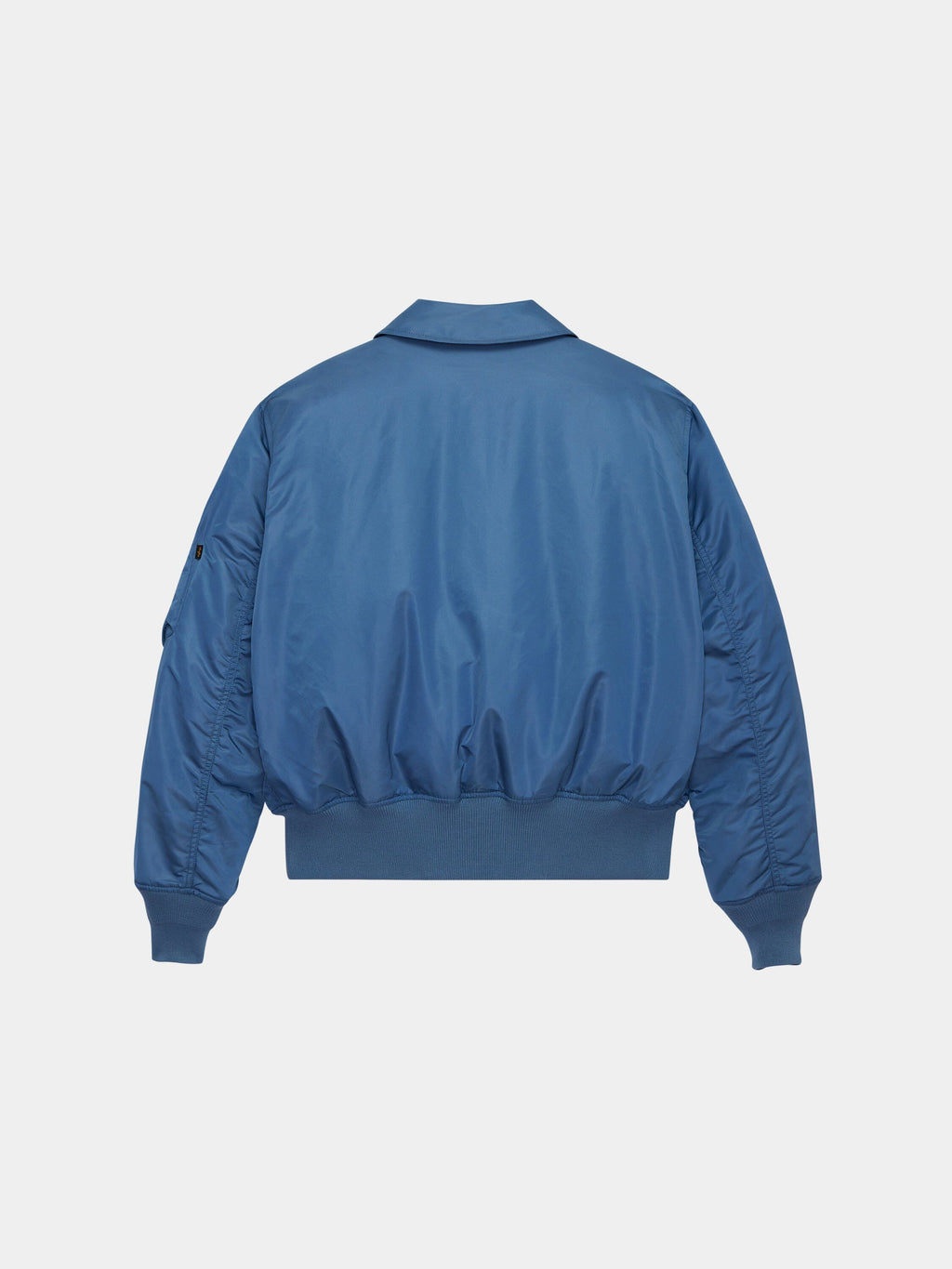 Cwu 45/P Bomber Jacket by Alpha Industries in blue with ribbed cuffs, waistband, and a collar inspired by military flight jackets.