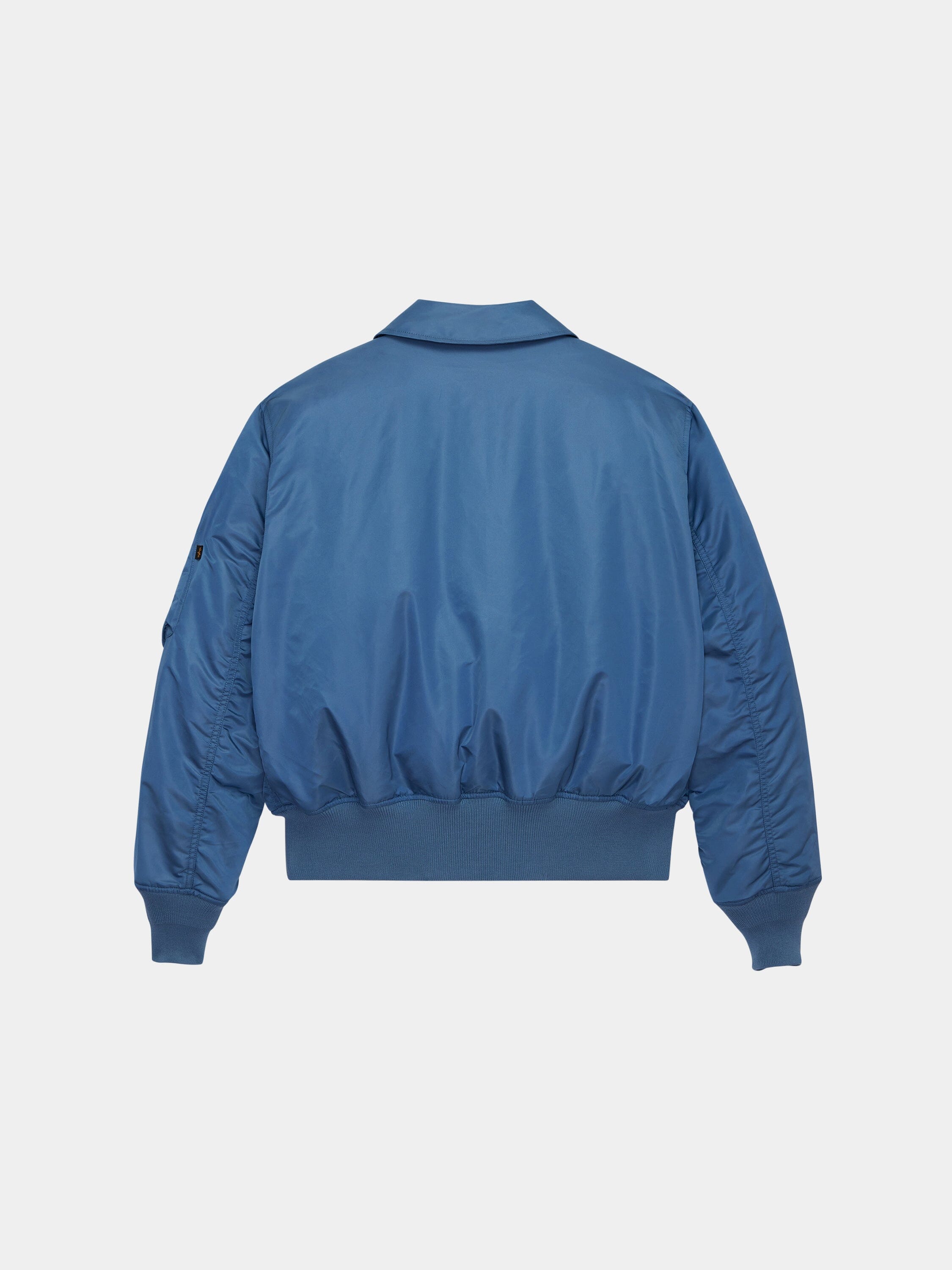Cwu 45/P Bomber Jacket by Alpha Industries in blue with ribbed cuffs, waistband, and a collar inspired by military flight jackets.