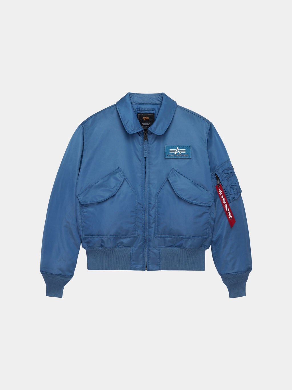 Alpha Industries Cwu 45/P Bomber Jacket in Elemental Blue with front flap pockets, zippered closure, left chest patch, red sleeve tag.