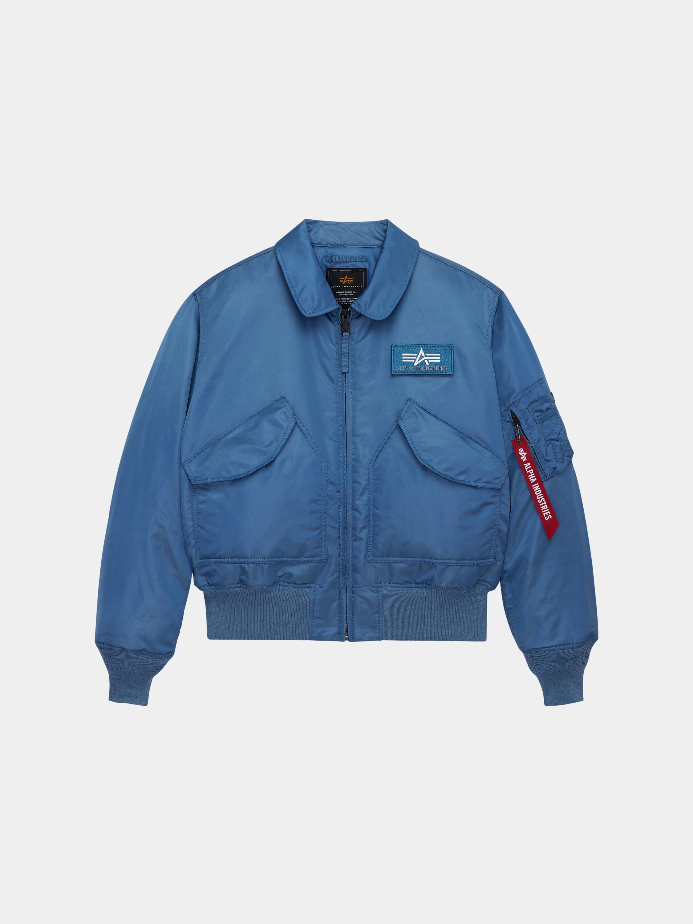 Alpha Industries Cwu 45/P Bomber Jacket in Elemental Blue with front flap pockets, zippered closure, left chest patch, red sleeve tag.