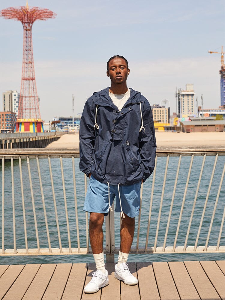 Alpha Industries Deck Shorts, navy jacket, white socks, sneakers.