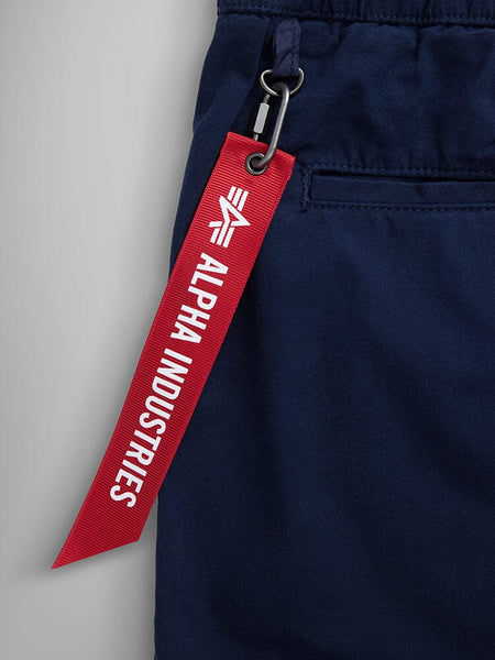 Alpha Industries Deck Shorts, Navy Blue, Breathable Fabric, Red Keychain with White Text.