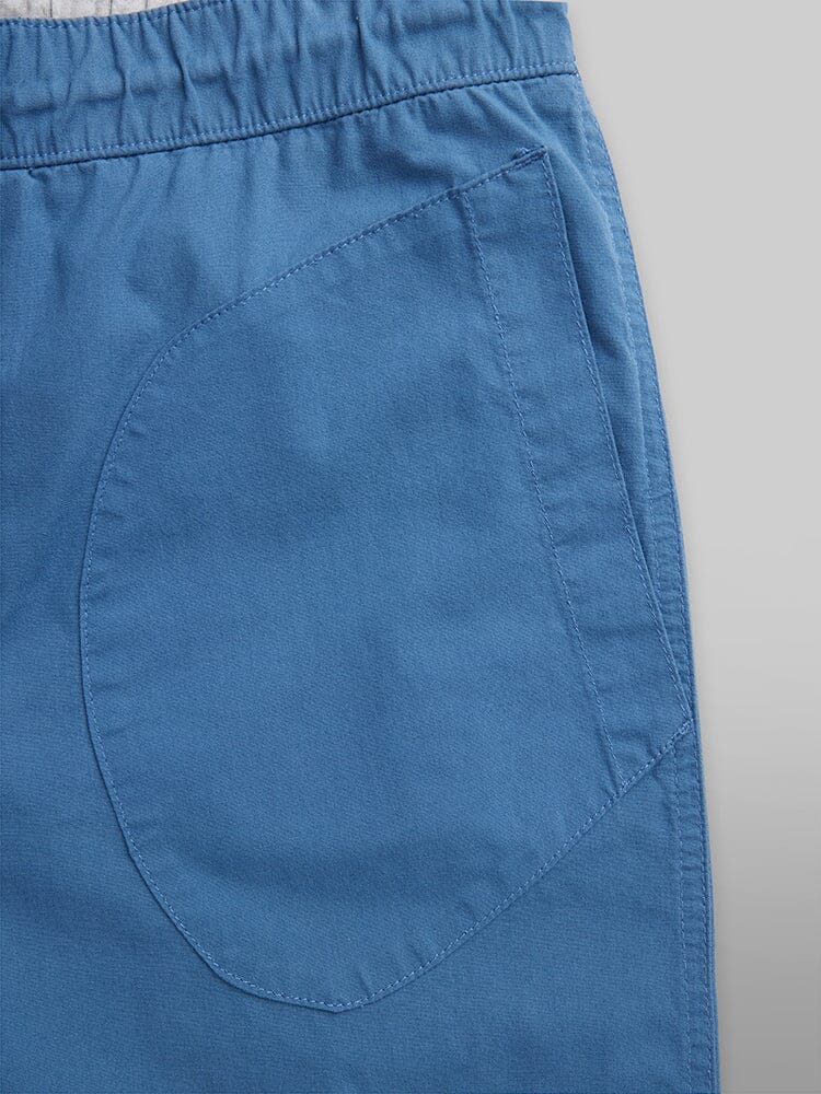 Alpha Industries Deck Shorts, blue elastic waistband, large curved side pocket, visible stitching.