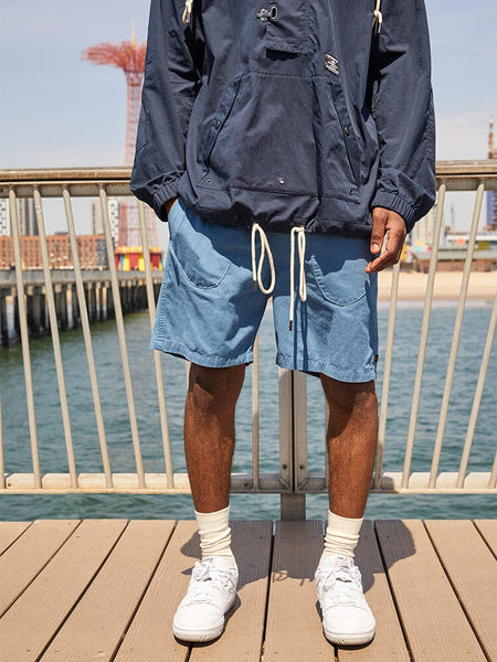 Alpha Industries Deck Shorts and Navy Jacket, featuring zip and button closures.