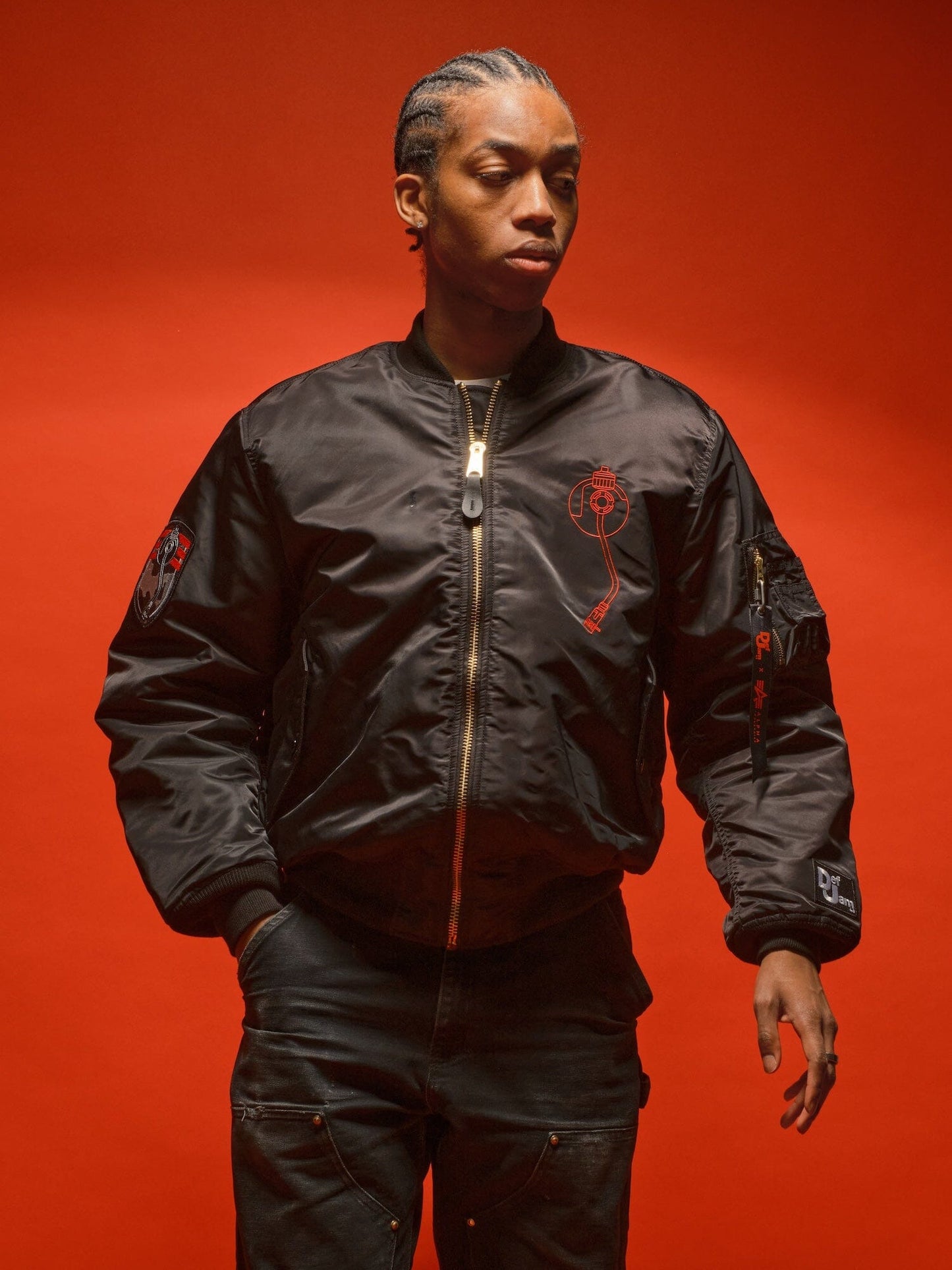 Alpha Industries MA-1 Bomber Jacket, black pants, solid red color, front zipper closure.