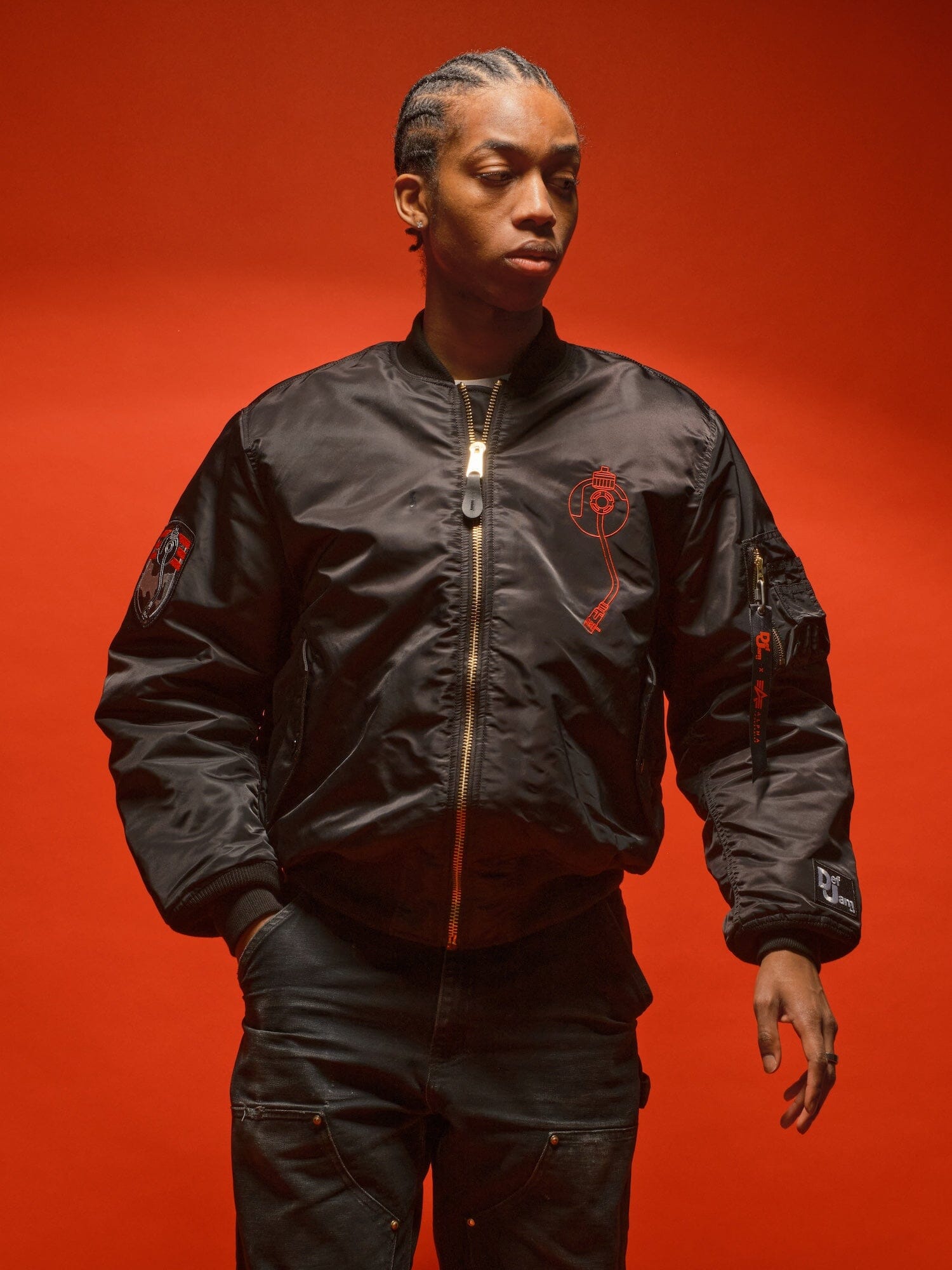 Alpha Industries MA-1 Bomber Jacket, black pants, solid red color, front zipper closure.