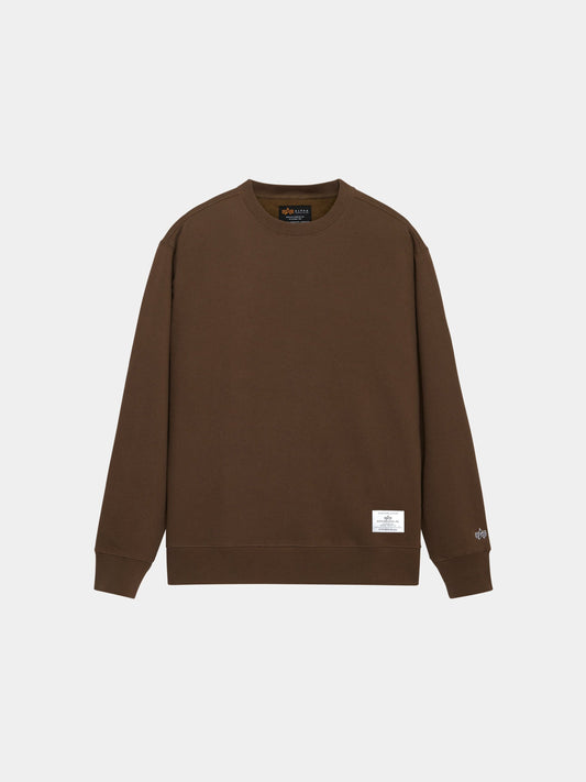 Alpha Industries Essential Crewneck in Espresso with long sleeves, ribbed cuffs and hem, logo on left sleeve, white tag near hem.