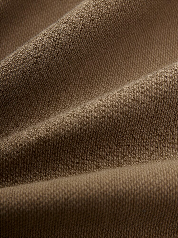 Close-up of the Essential Crewneck in brown from Alpha Industries.