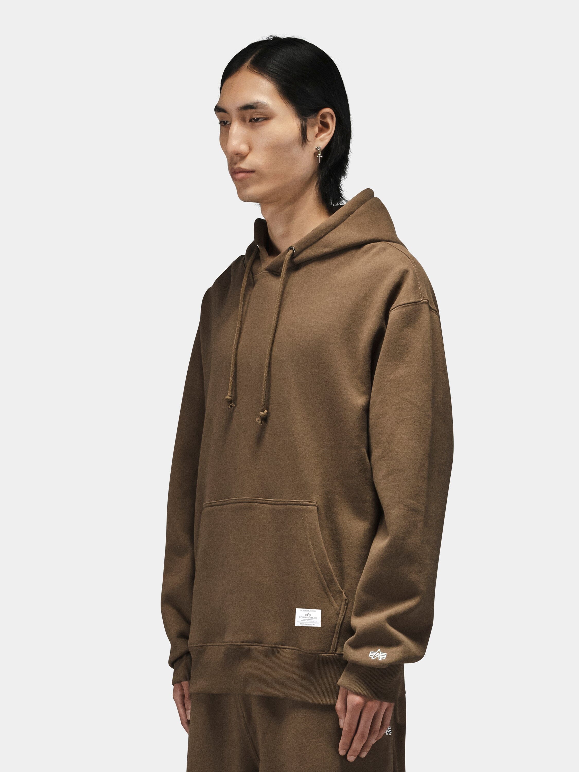 Alpha Industries Essential Hoodie and matching pants in dark color, featuring pullover design with drawstring hood.