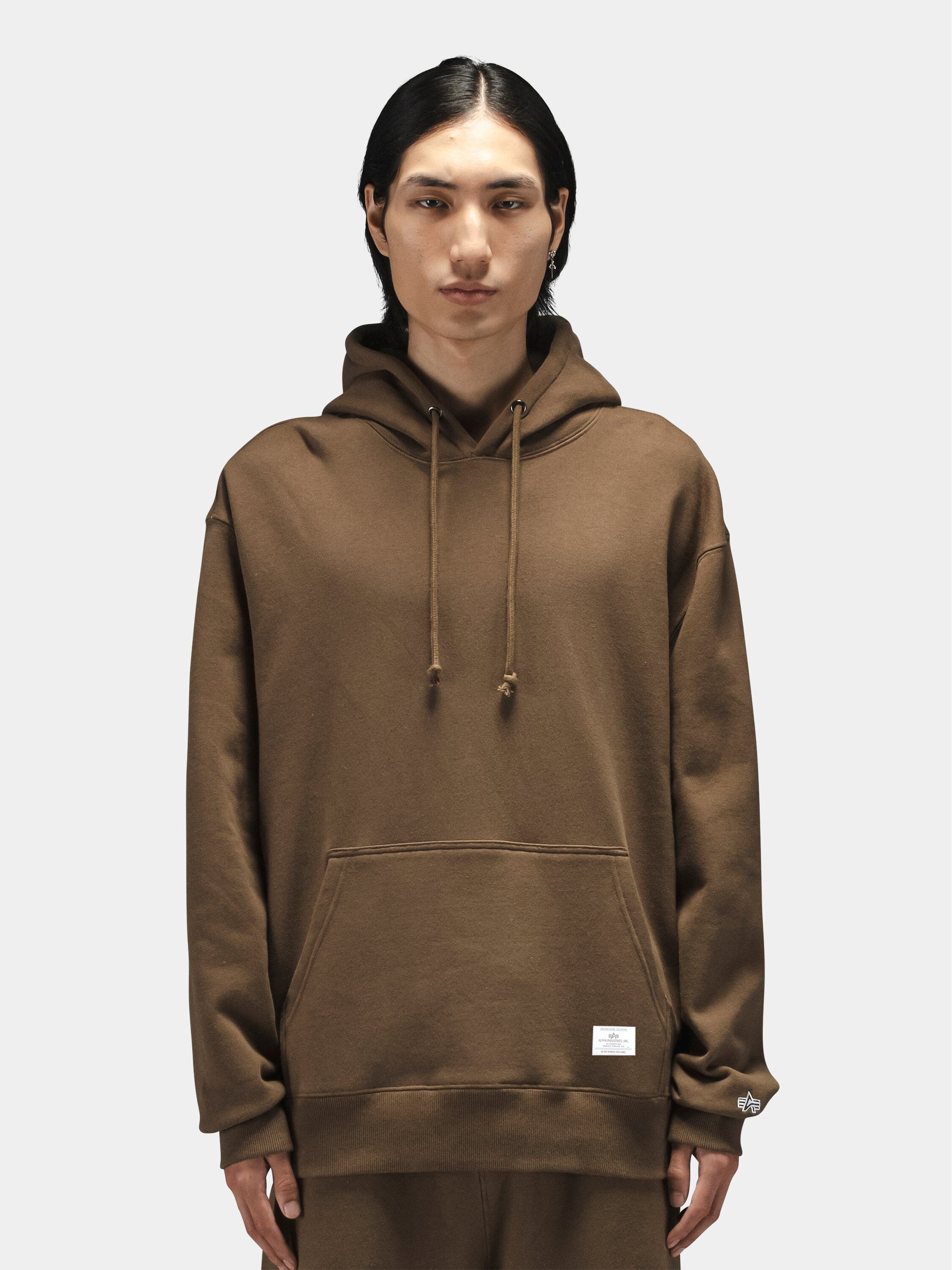 Alpha Industries Essential Hoodie in brown with front pocket and drawstrings.