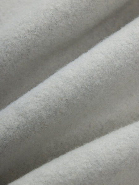 Close-up of soft, light gray cotton fabric with a textured, fuzzy surface from the Women's Essential Sweatpants by Alpha Industries.