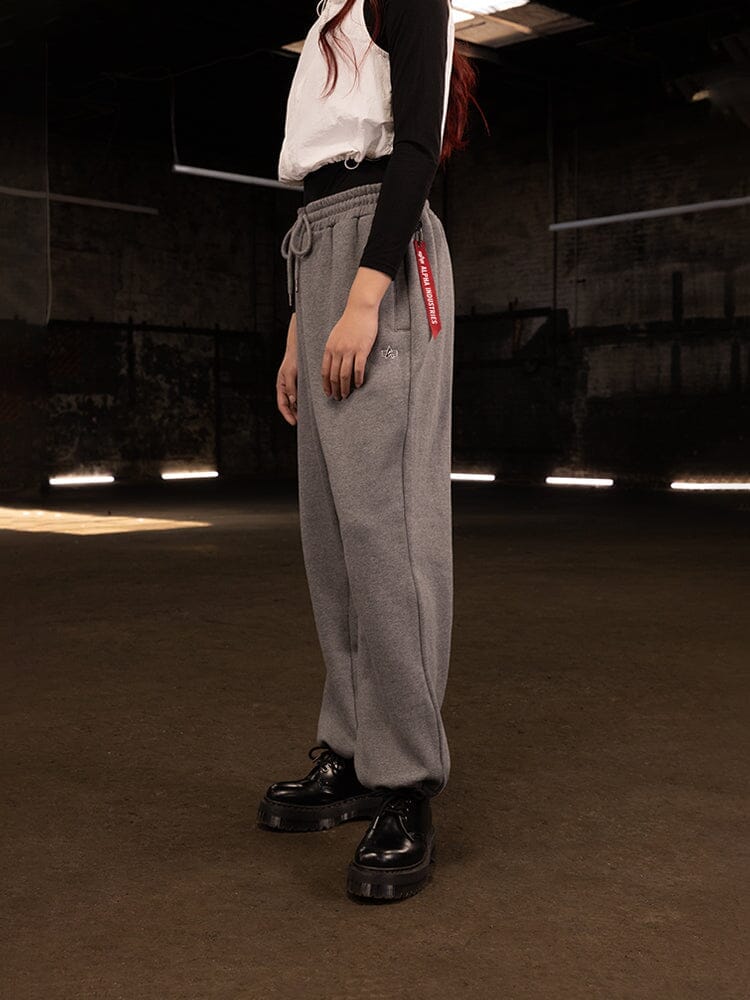 Alpha Industries Essential Sweatpants in gray, black-and-white long sleeve shirt, black platform shoes.