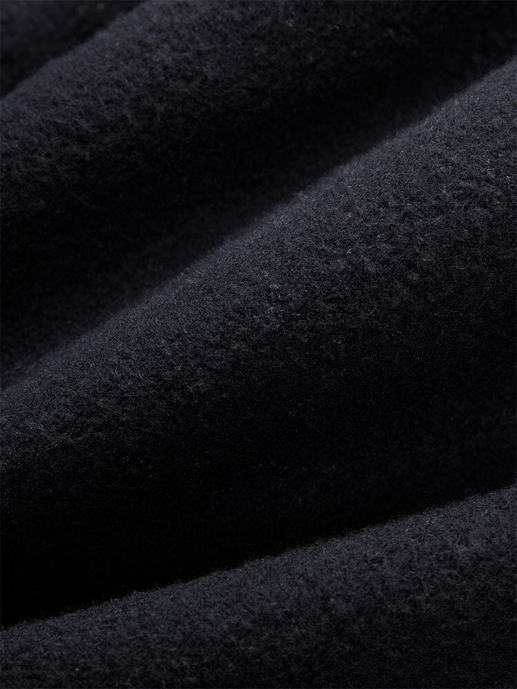 Close-Up of the black fleece material from the Women's Essential Sweatpants by Alpha Industries, showcasing a visible texture and inviting folds that recall cozy comfort.