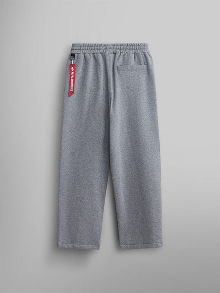 Back view of the gray Women's Essential Sweatpants from Alpha Industries. Made from soft cotton fabric, featuring an elastic waistband and a chic red tag on the side.