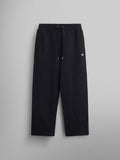 The Women's Essential Sweatpants by Alpha Industries are black and crafted from soft cotton. They come with an elastic waistband and a small embroidered logo on the upper left.