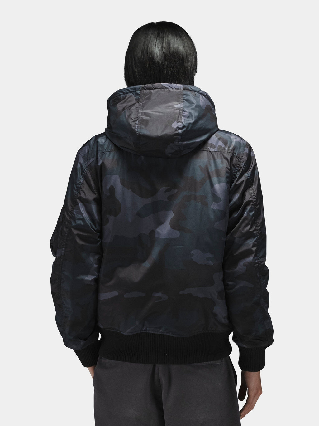 Alpha Industries Hooded Rib Flight Jacket with utility sleeve pocket and dark pants.