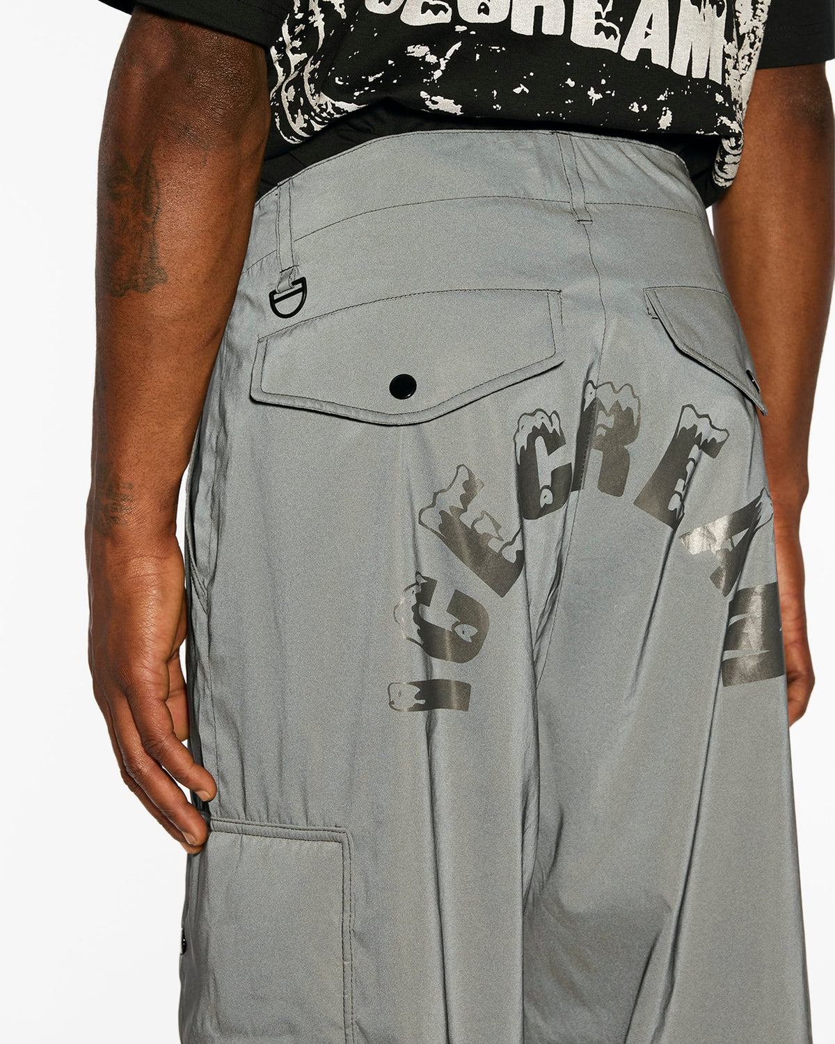 ICECREAM X ALPHA FUR PATCH PANT - On model - back close-up reflective wordmark