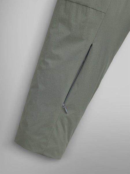 Close-up shot featuring a green insulated shirt jacket from Alpha Industries, highlighting its diagonal zipper pocket for a streetwear vibe.