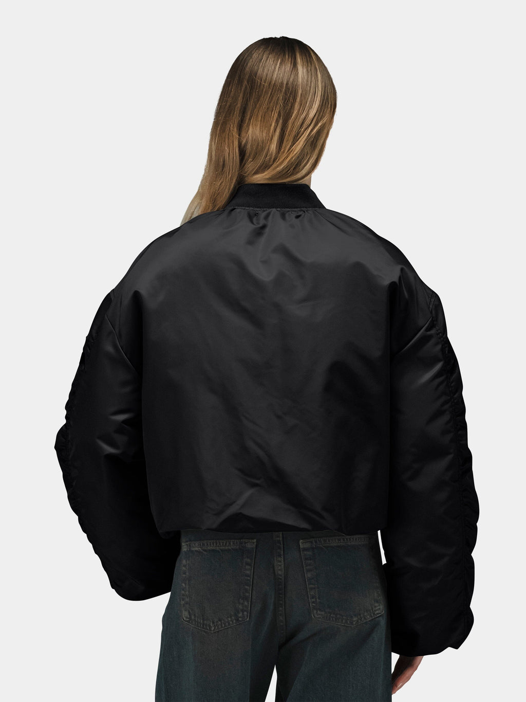 Alpha Industries Knit Rib MA-1 Flight Jacket Womens in black with ribbed knit details, paired with dark jeans.