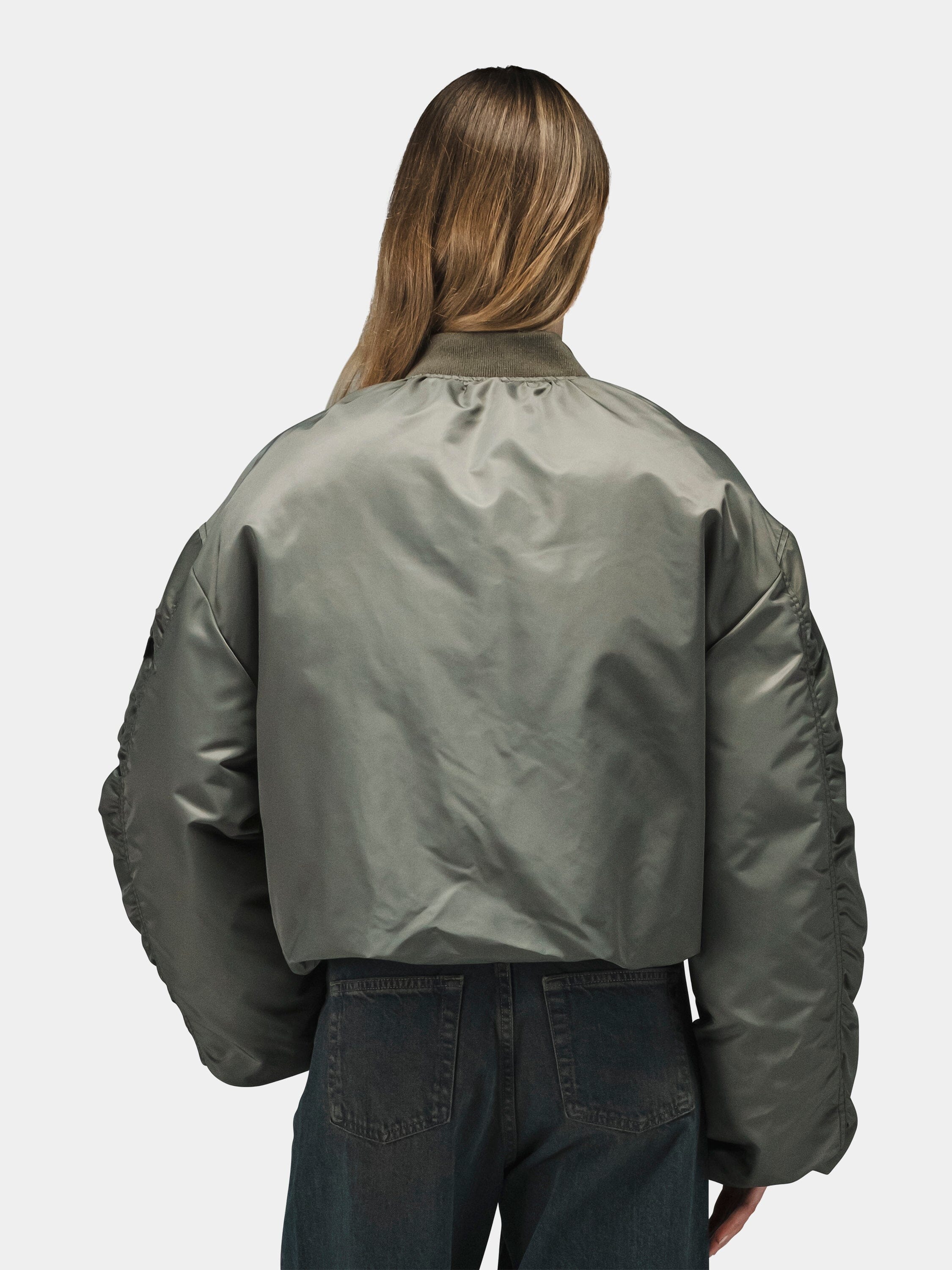 Alpha Industries Knit Rib MA-1 Flight Jacket Womens in olive green with dark jeans.