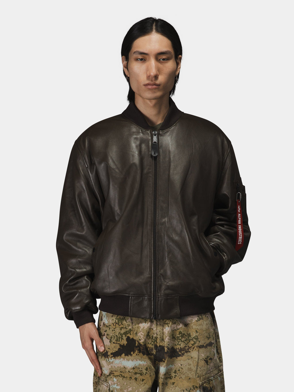 Alpha Industries Leather MA-1 Flight Jacket in dark brown with camouflage pants.