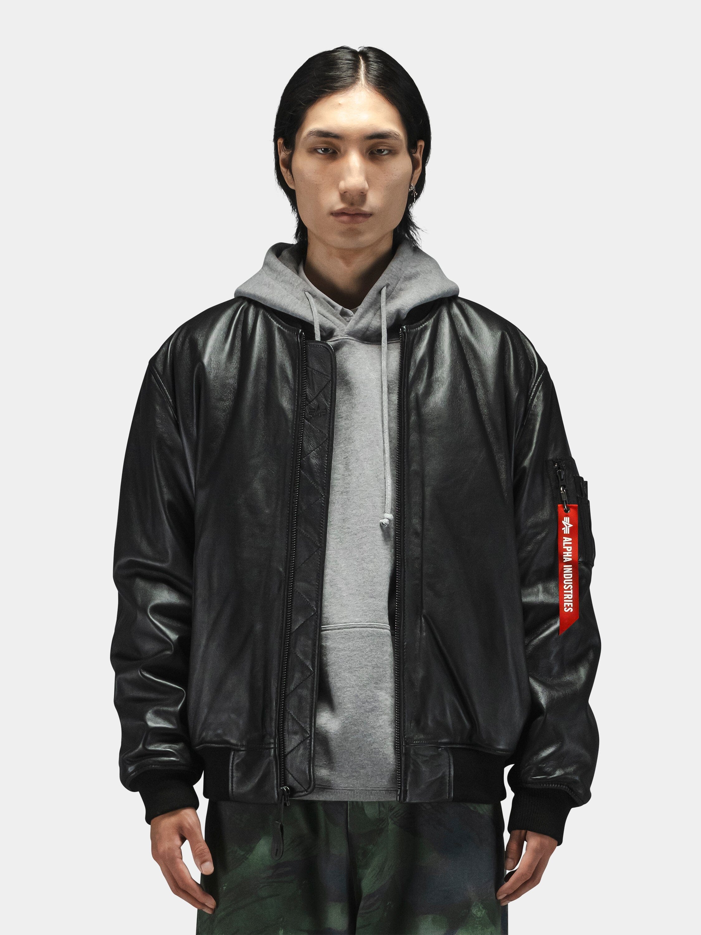 Alpha Industries Leather MA-1 Flight Jacket, black leather, front zipper, ribbed cuffs and hem. Gray hoodie. Green camo pants.