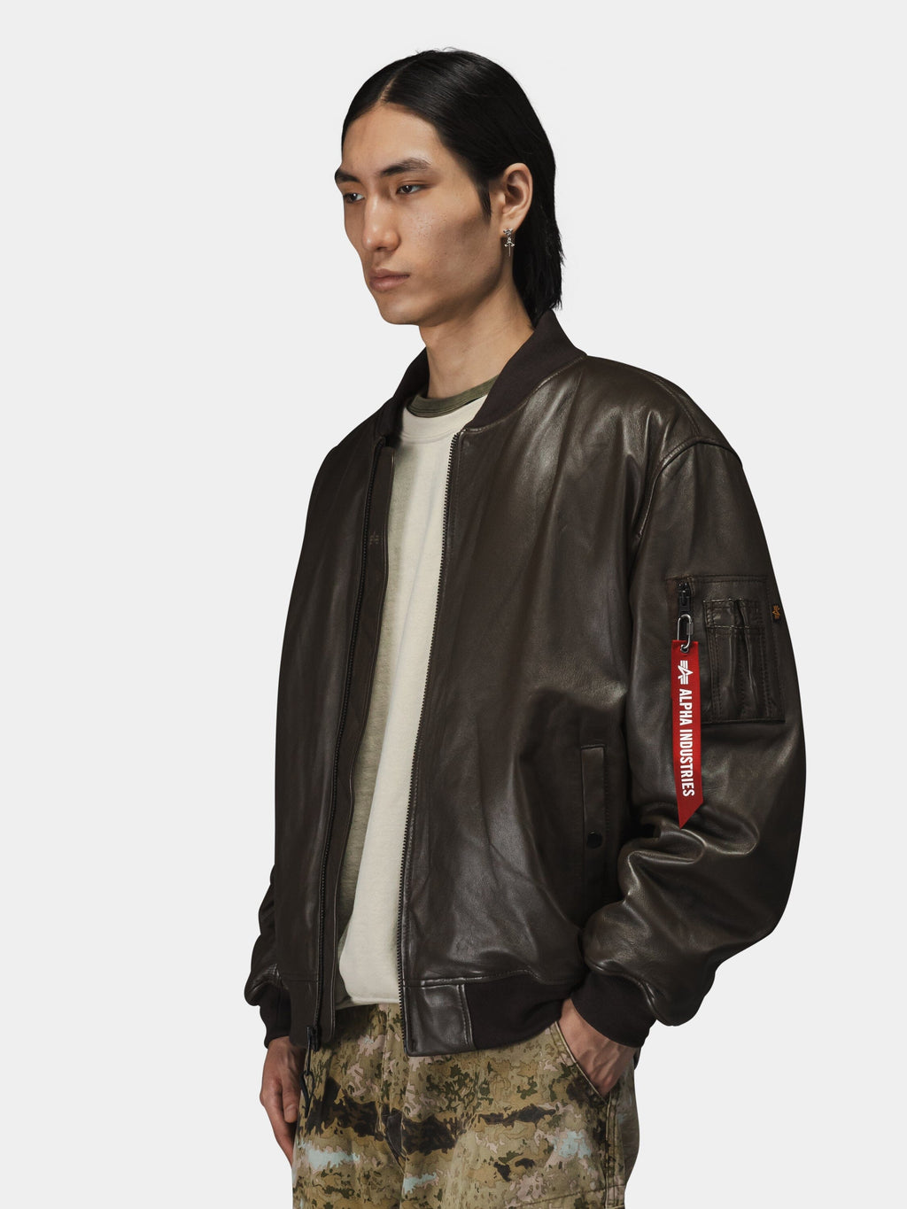 Alpha Industries Leather MA-1 Flight Jacket in dark brown, leather material, zip closure.
