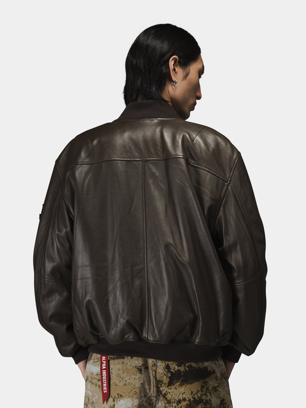 Alpha Industries MA-1 Flight Jacket in leather with camouflage pants.