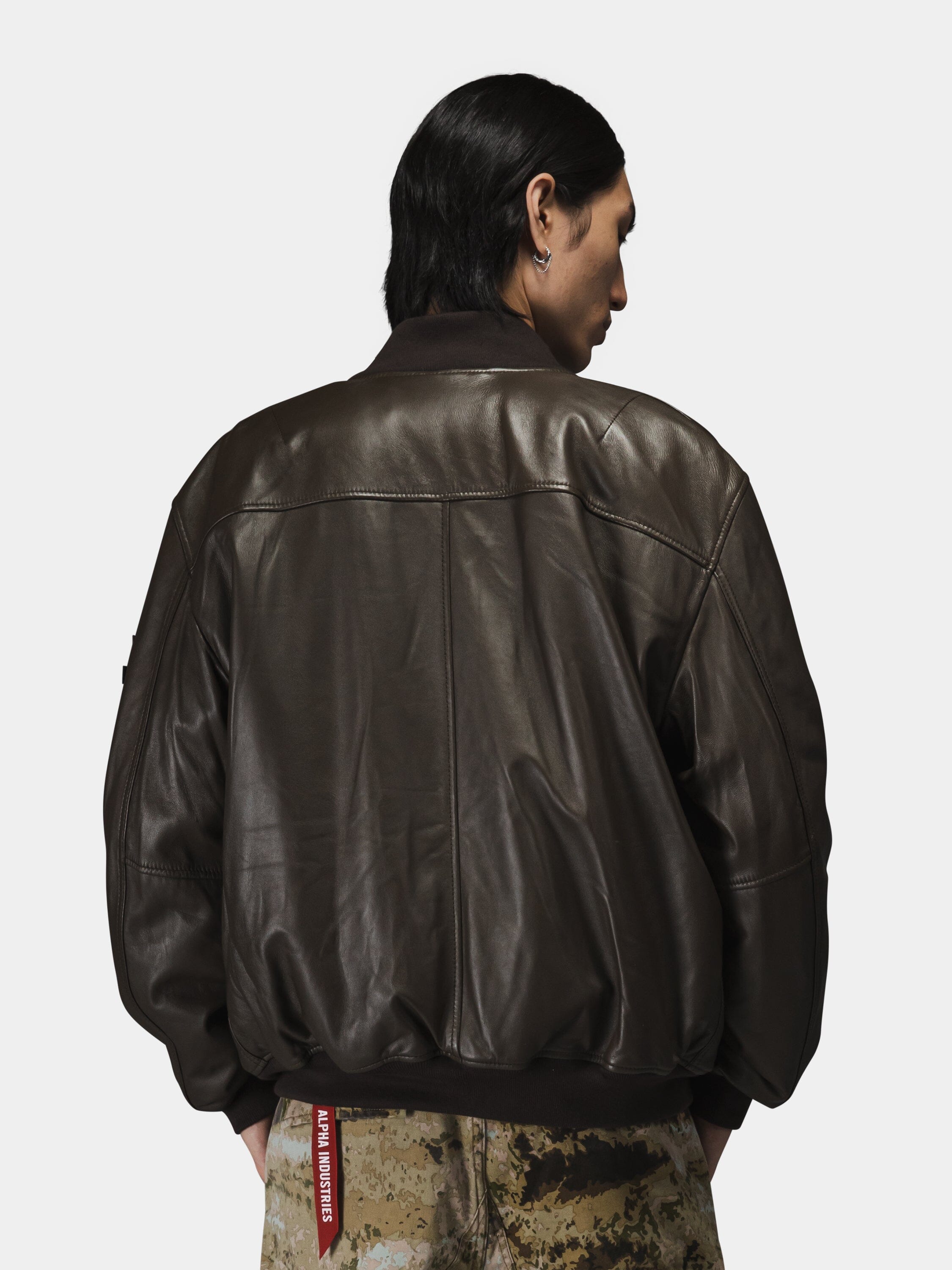 Alpha Industries MA-1 Flight Jacket in leather with camouflage pants.
