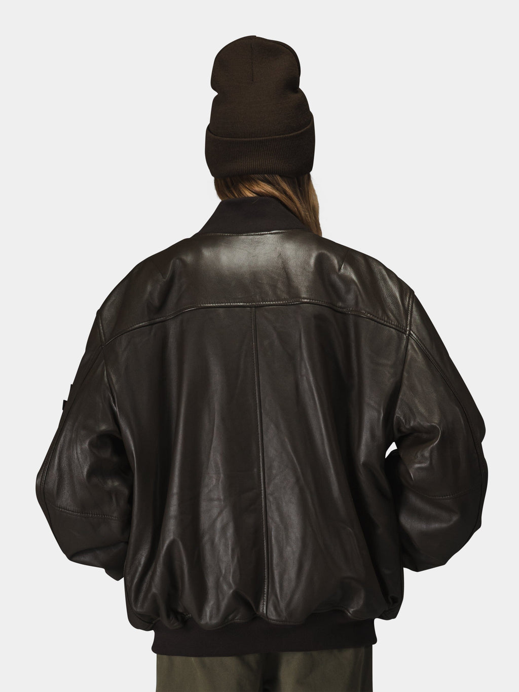 Alpha Industries Leather MA-1 Flight Jacket, dark brown beanie, leather material, MA-1 design.