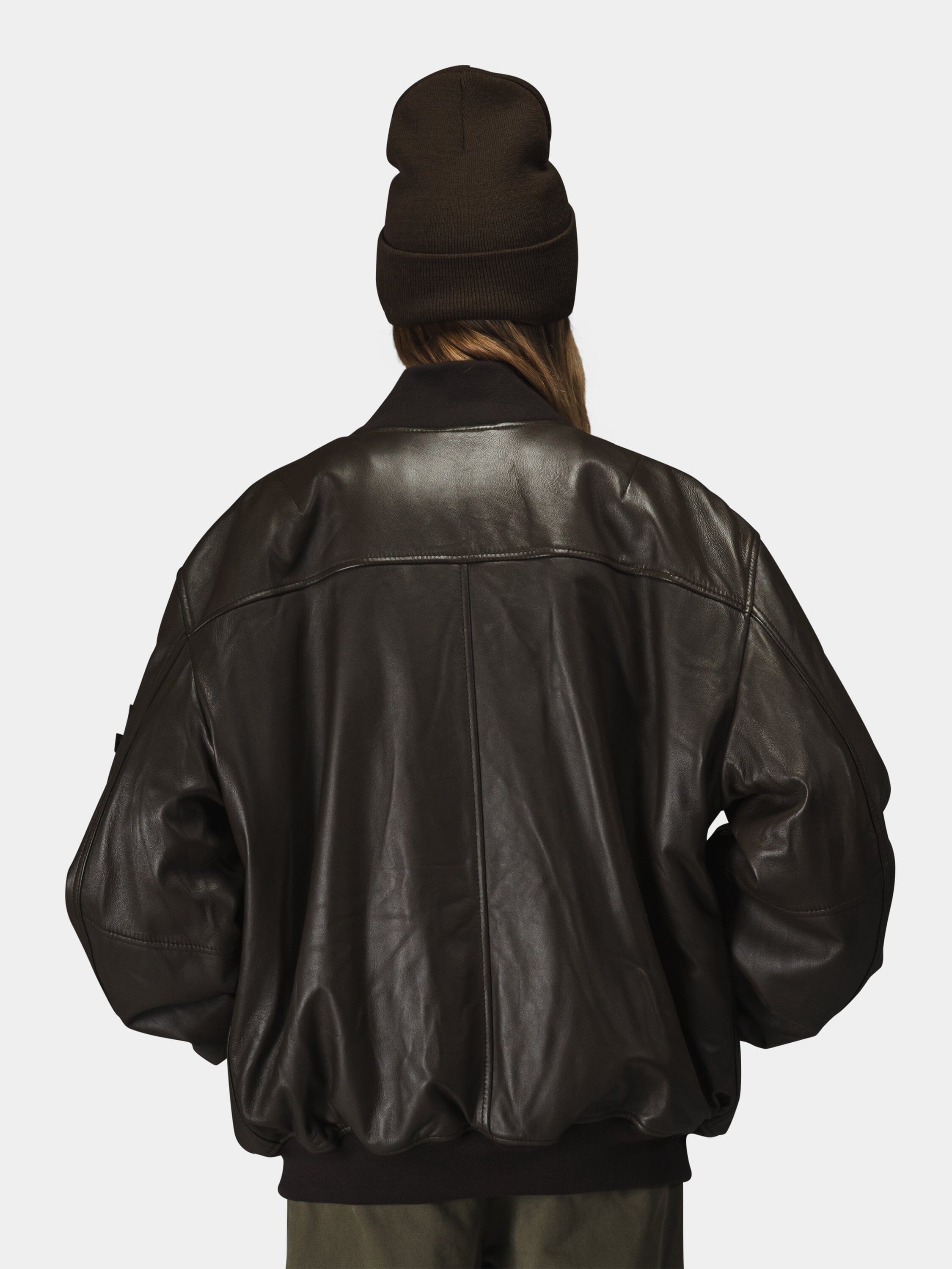 Alpha Industries Leather MA-1 Flight Jacket, dark brown beanie, leather material, MA-1 design.