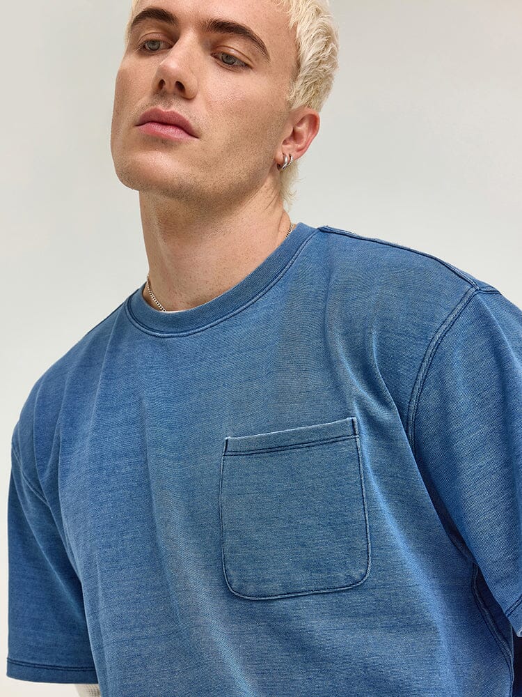 A person wearing an Alpha Industries FW24-Lee Looser Fit Indigo Dyed Tee.