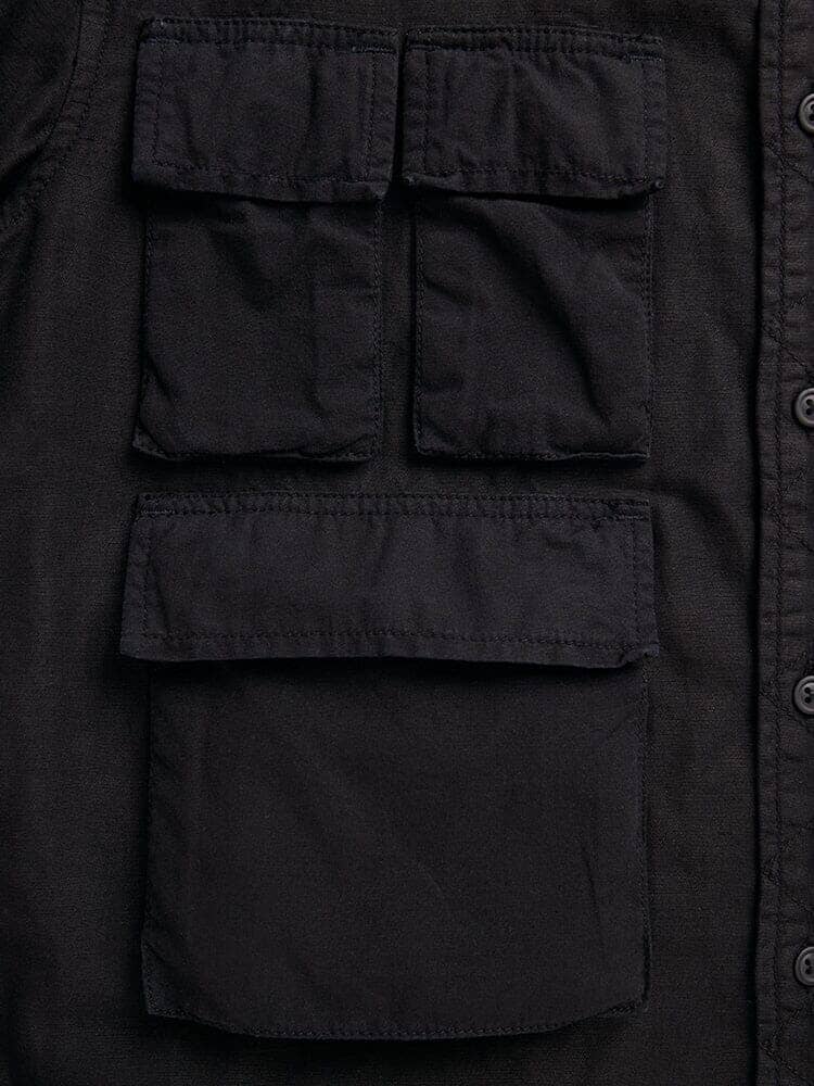 Alpha Industries Long Sleeve Multi Pocket Shirt, black, rectangular front flap pockets—two small above a larger pocket, button closure down right edge.