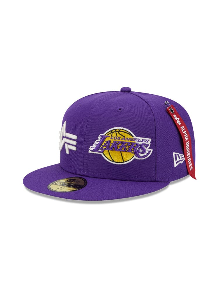 Purple Los Angeles Laker X Alpha X New Era 59Fifty Fitted Cap showcasing the iconic team logo, enhanced with an Alpha Industries® tag on the side.