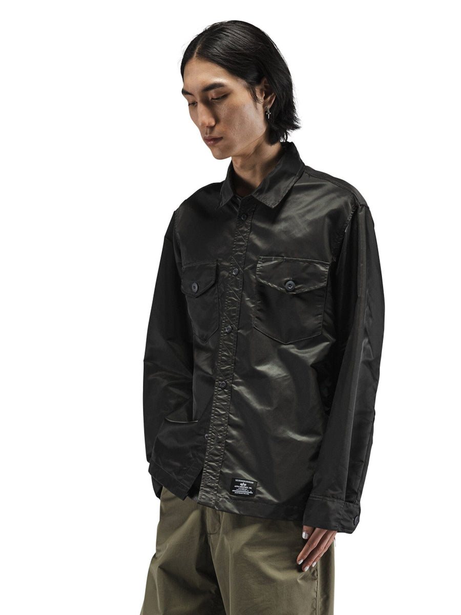 Alpha Industries LS Flight Overshirt in black nylon with chest pockets and olive green pants.
