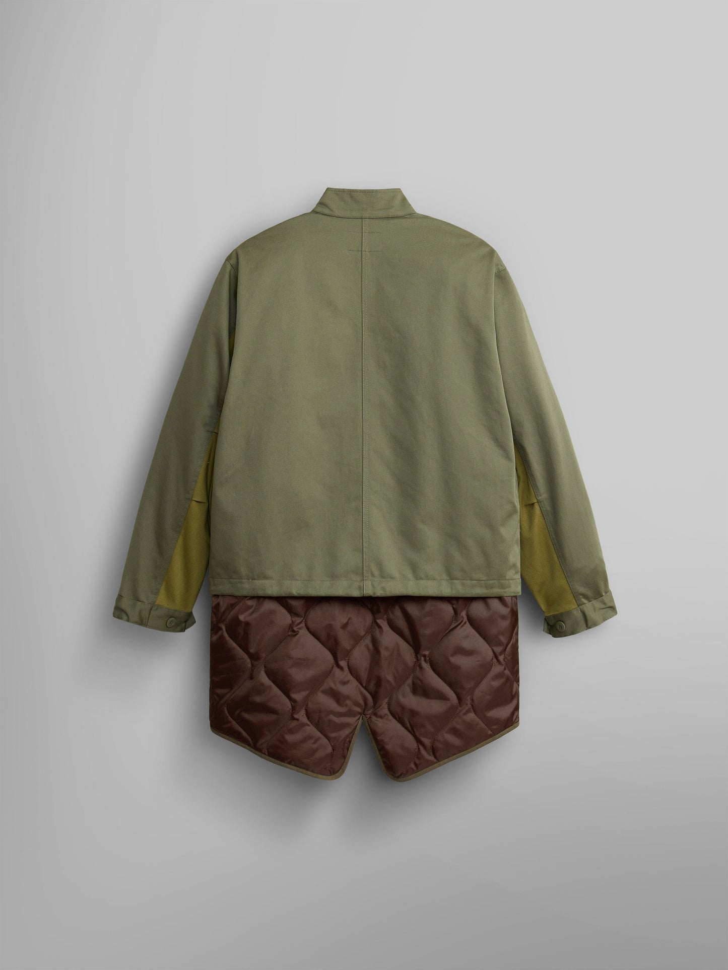Back view of the M-65 Long Liner by Alpha Industries, featuring a green design with yellow accents and quilted brown shorts, complete with an onion quilted lining for enhanced texture.
