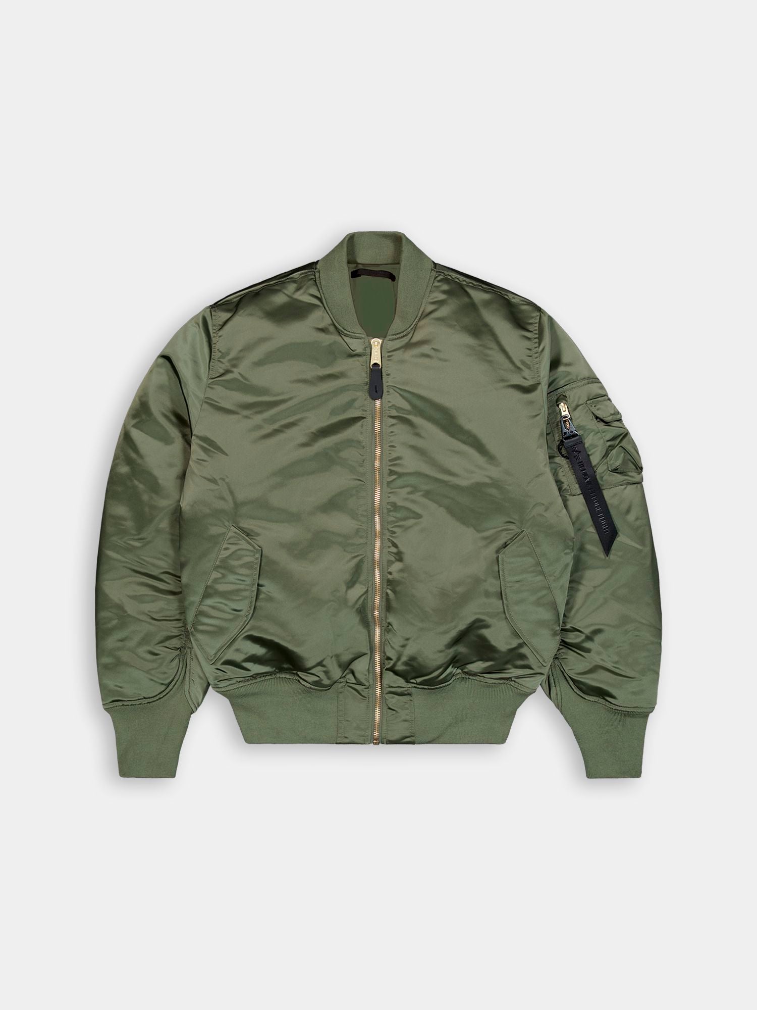 Alpha Industries MA-1 jacket in sage with front zipper, ribbed cuffs and hem, angled front pockets, zippered sleeve pocket with black tag.