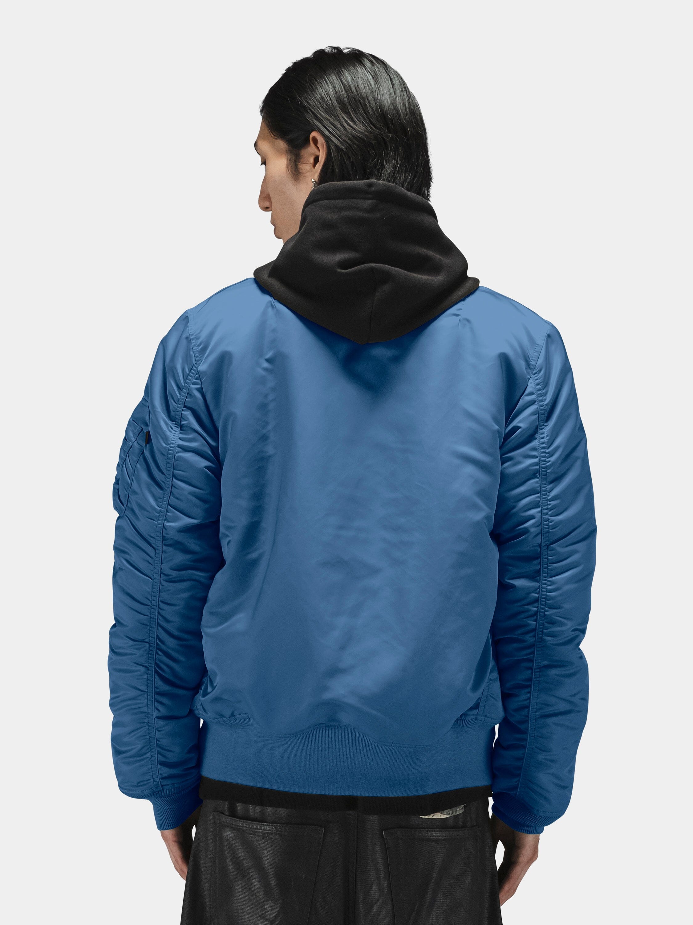 Blue Alpha Industries MA-1 Bomber Jacket over black hooded sweatshirt.